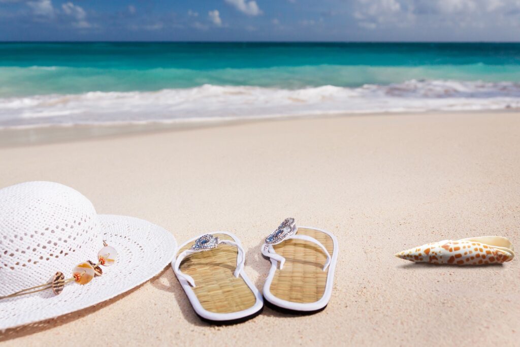 hat and sandals on beach